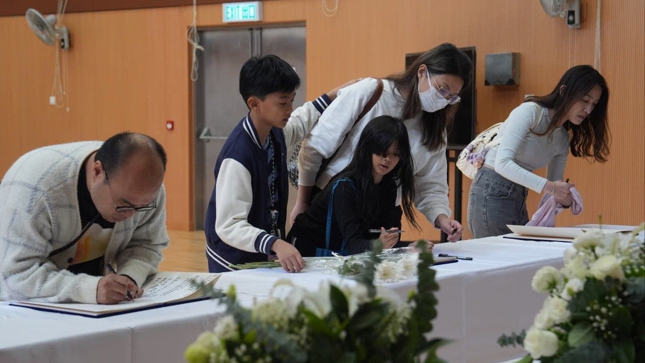 Sense of sombre unity as Hong Kong mourns 128 killed in blaze