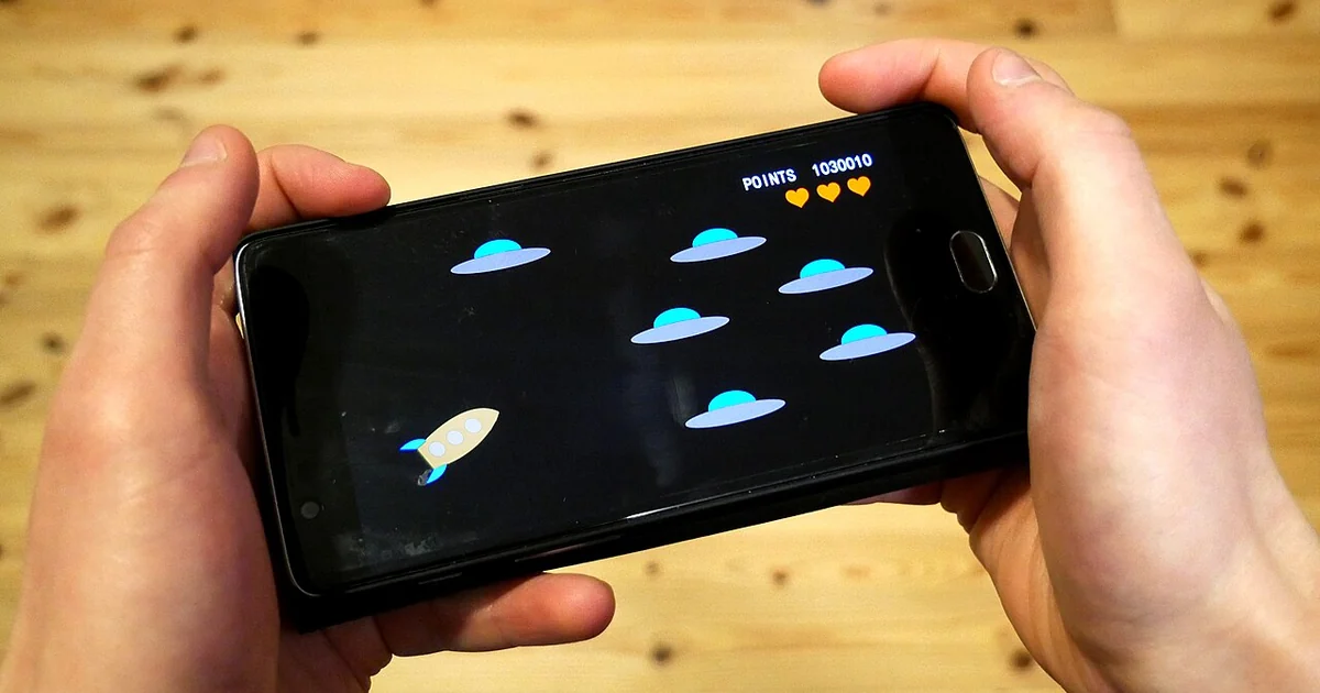 Playing video game with smartphone.